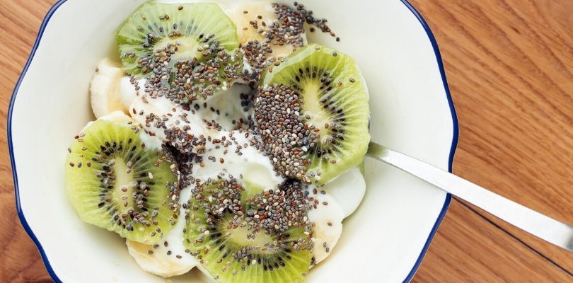 A bowel of yogurt with kiwi and chia seeds.